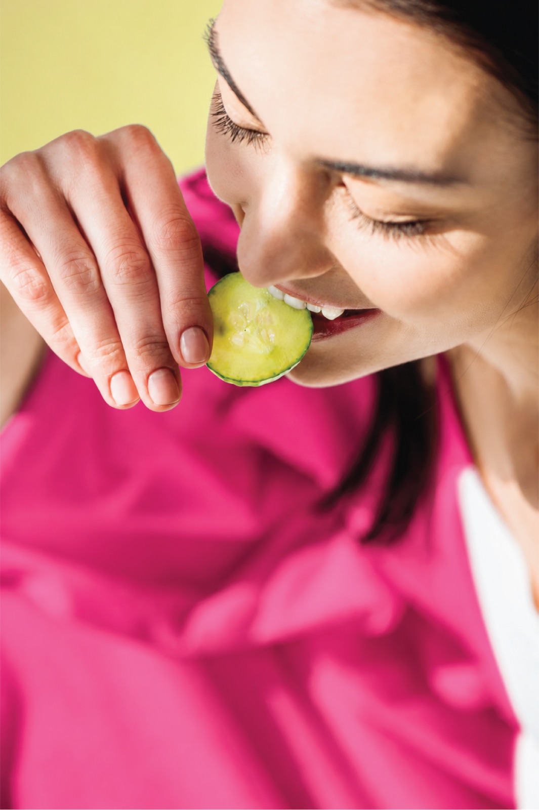 Close-up of a woman tasting a pickle