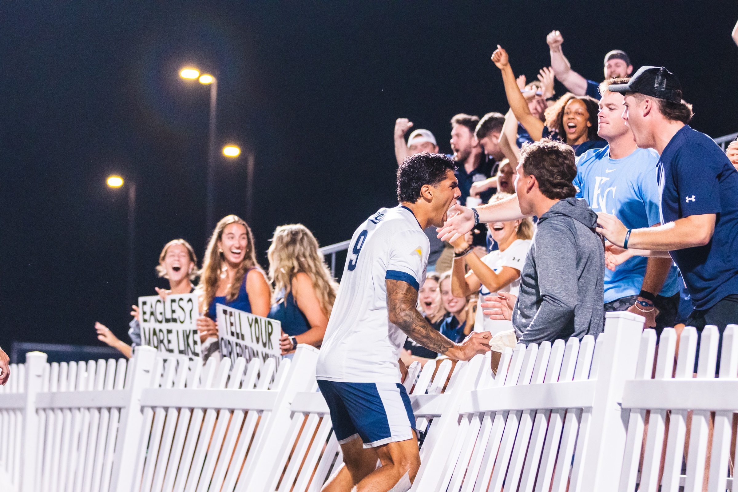 UNF men’s soccer player celebrating with fans at Hodges Stadium